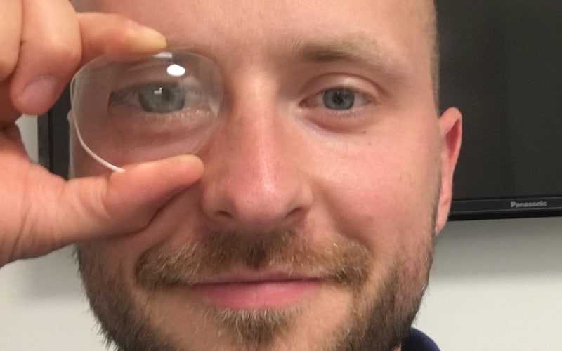 This picture shows the master optician Michael Penczek with a plus lens in front of his eye to show the magnifying effect 